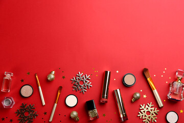 Flat lay composition with decorative cosmetic products on red background, space for text. Winter care