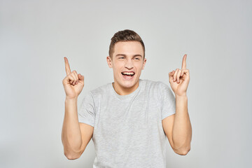 handsome man in light t-shirt cropped view emotion studio isolated background