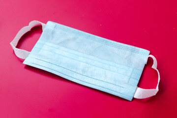 Blue medical mask on a red background