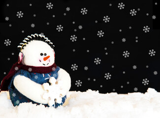 Happy Snowman in snow on black background. Holiday theme