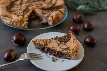 Fototapeta na wymiar Delicious chestnut cake with almonds and chocolate glaze