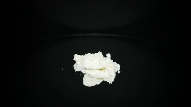 Addictive cocaine illegal drug product on black turntable