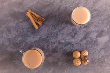Obraz na płótnie Canvas Flat lay christmas composition of two glass cup with winter hot drink cocoa and cinnamon. Copy space for text