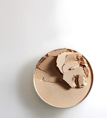 close up of a make up powder on white background