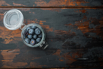 Blueberry in glass jar, flat lay with space for text on old wooden background