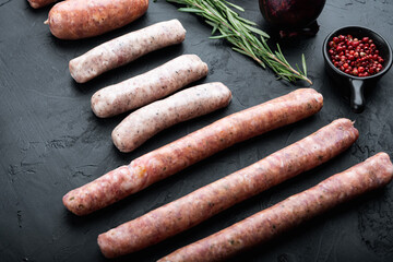 Raw sausages, on black background