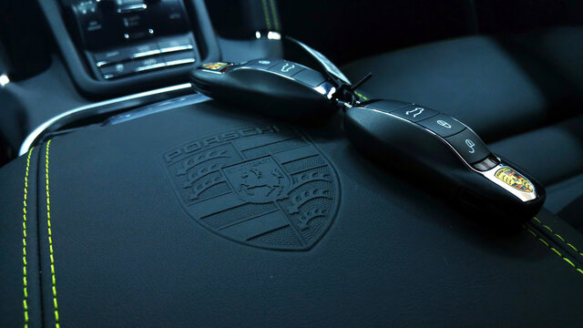 Moscow. Autumn 2018. Keys from New Porsche Cayenne Turbo. Stamping on the leather armrest and green stroke stitching