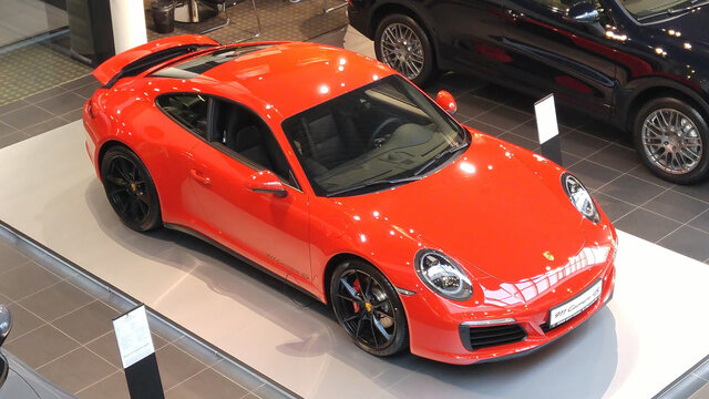 Moscow. Winter 2019. Bright Orange Porsche Carrera 911 991 4s in showroom. Top view