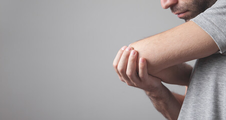 Caucasian man with elbow pain. Pain relief concept