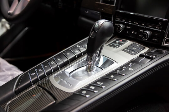 Moscow. November 2018. The shift knob of the full-size luxury car Porsche Panamera Turbo. Carbon panel with logo, shiftgear PDK