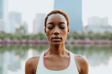 Woman meditating in the urban park