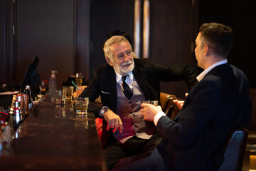 Celebration, Party People concept. Business peoples man and woman Enjoying Evening Drinks in executive bar.