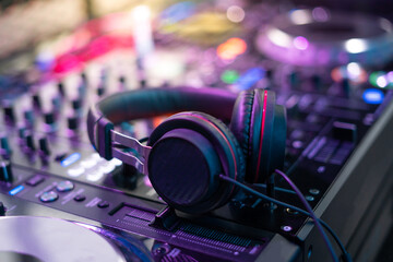 Fototapeta na wymiar Close up of Dj mixes the track in nightclub at party. Hands of dj tweak various track controls on dj's deck.