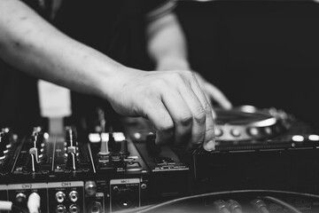 Close up of Dj mixes the track in nightclub at party. Hands of dj tweak various track controls on...