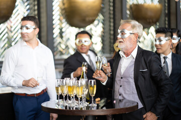 Masquerade party. Beautiful women and men wearing fantasy mask. Company employee enjoy drinking in mask party  together indoors celebration