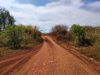 The red dirt road is used as a bicycle track beside the lake