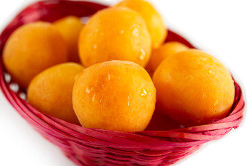 organic apricots in a pink basket