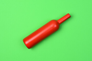 red glass bottle on green background