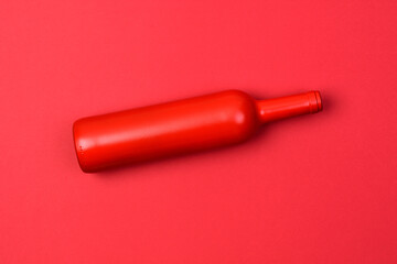 red bottle on red background