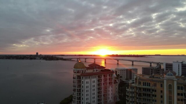 Bay area of Sarasota, Florida during sunset. Drone footage of Golden Gate Point and the Ringling bridge with the sunset in the background. Shot in 24 fps.