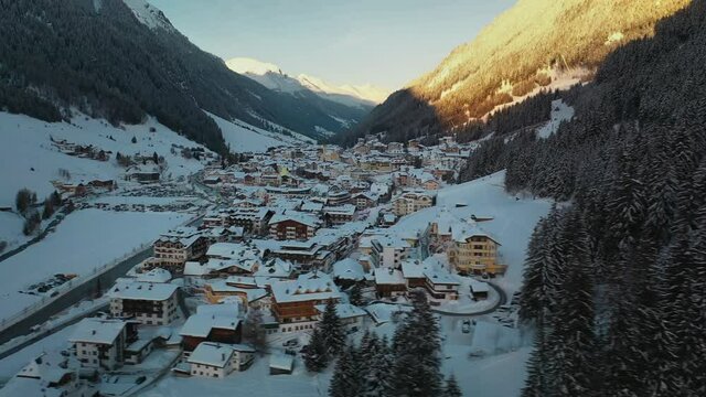 Beautiful ski resort village in Austrian Alps mountain valley, winter aerial