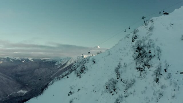 Ski Chairlift Ascending to Mountaintop & Beautiful Winter Background