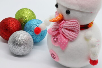 colorful and glowing toy balls, christmas celebration background and snowman toy