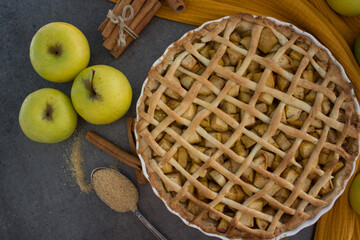 Apple pie on fabric textured background. Classic American tart close up. Autumn menu ideas. 