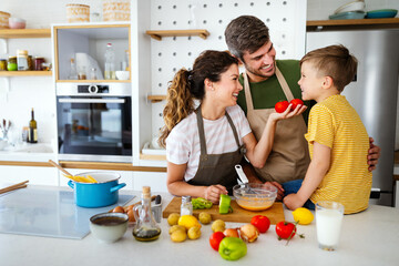 Happy family in the kitchen having fun and cooking together.