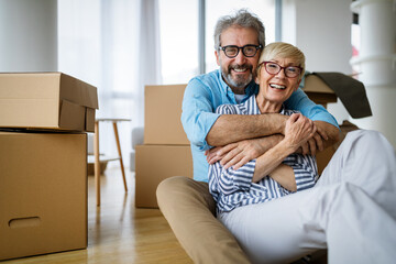 Portrait of happy senior couple in love moving in new home