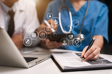 Doctors working together on digital tablet healthcare doctor technology tablet using computer in a...