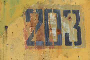 Metal wall with a number. Number 203 on vintage metallic texture