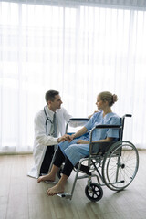 Fototapeta na wymiar Doctor talking and consultant to patient in wheelchair at hospital.