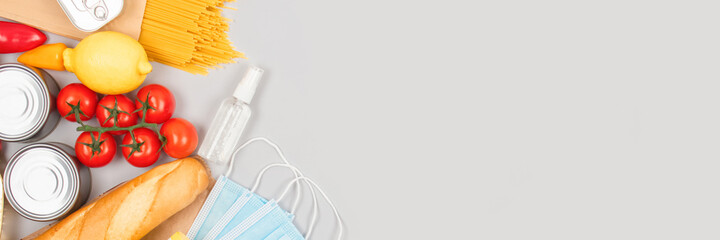 Banner with food and medicines donations on grey background with copyspace - pasta, fresh vegatables, canned food, baguette, cooking oil. Food donations and food bank concept, flat lay