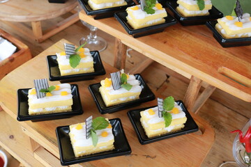 Slice of delicious vanilla cake on wooden table.