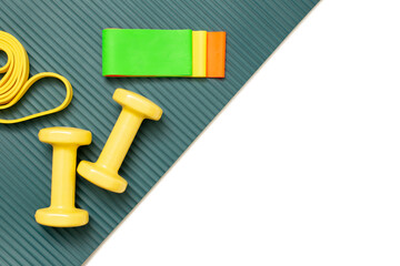 Flat view sports set: dumbbells and a set of multi-colored elastic bands