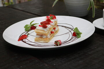 Strawberry Mille Feuille cake in white plate.