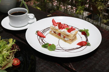 Strawberry Mille Feuille cake in white plate.