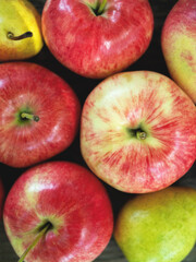 Delicious country apples and pears closeup on the bench.
