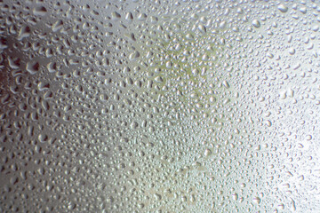 Water drops on glass. Back light. Photo Taken with selective focus and noise effect.