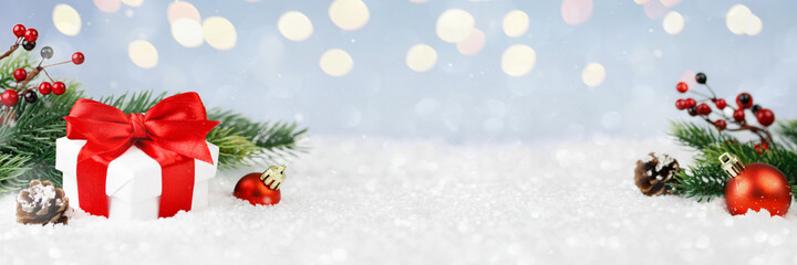 Wide panorama banner design image with festive Christmas decoration ornaments in winter landscape...