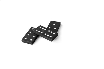 Black dominoes standing on isolated white background