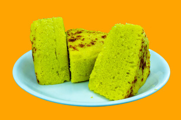 Gujarati famous dhokla peace in white plate Isolated with Saffron Color Background