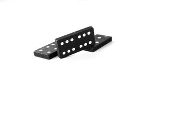 Black dominoes standing on isolated white background