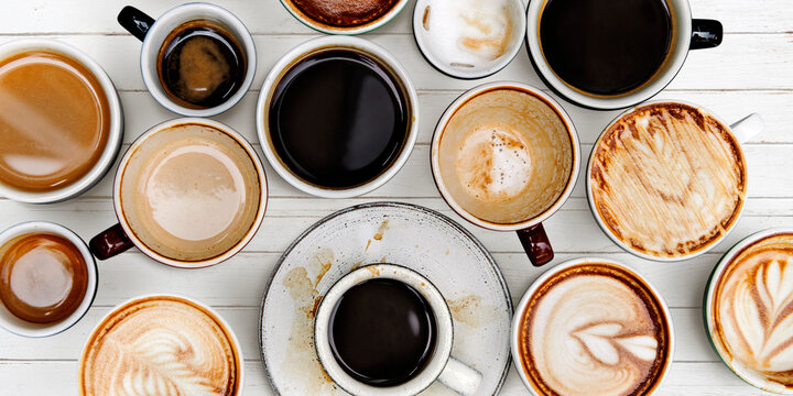 Coffee cups on a white wooden panel