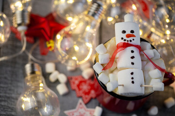 a marshmallow snowman with a red coffee Cup in a close-up Christmas decoration