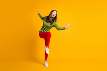 Fototapeta na wymiar Full length body size view of pretty ecstatic overjoyed cheery girl jumping having fun dancing isolated bright yellow color background