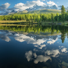 Picturesque mountain lake in the summer morning, Altai. Beautiful reflection of mountains, sky and white clouds.