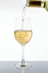 Pouring white wine from awine bottle