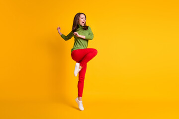Fototapeta na wymiar Full length body size view of nice careless funky cheerful girl jumping dancing enjoying having fun isolated vivid yellow color background